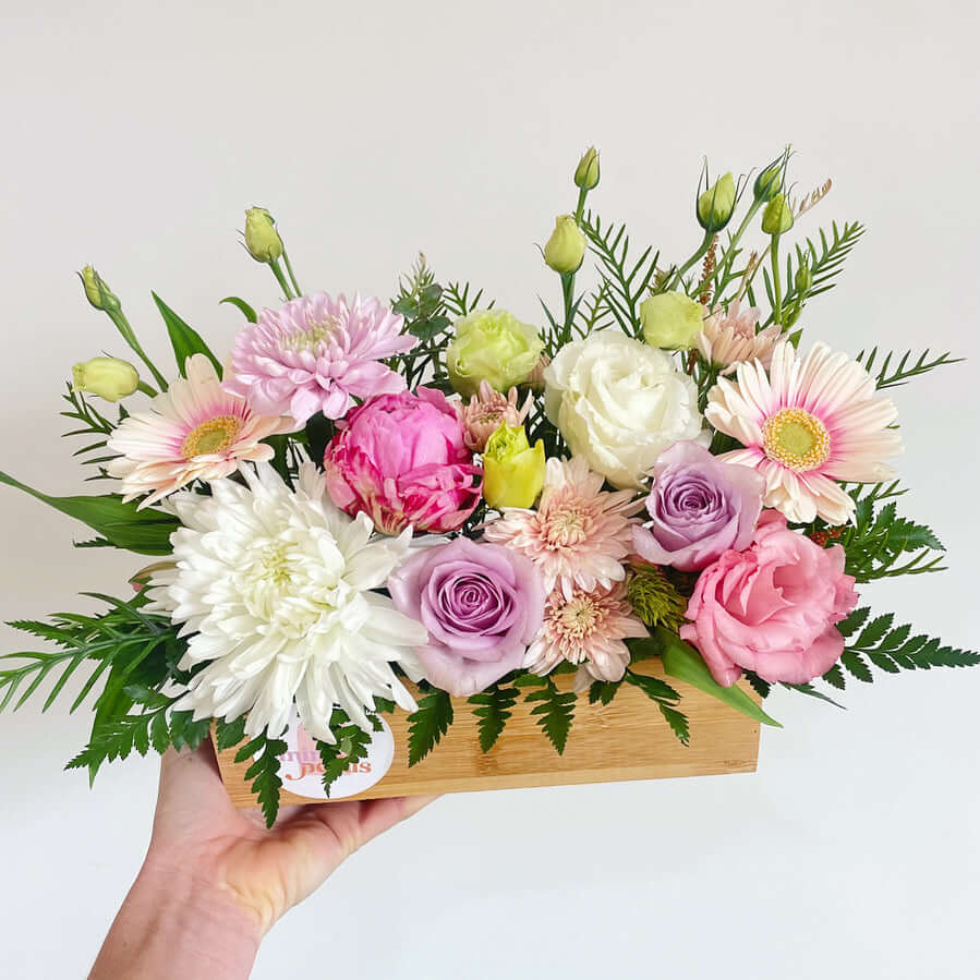 Pastel flower arrangement in crate display